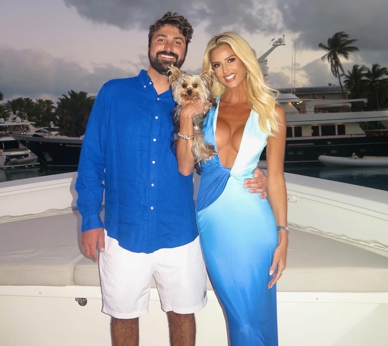Blake Davis and Emma Hernan Pose with a Yorkie on a Boat